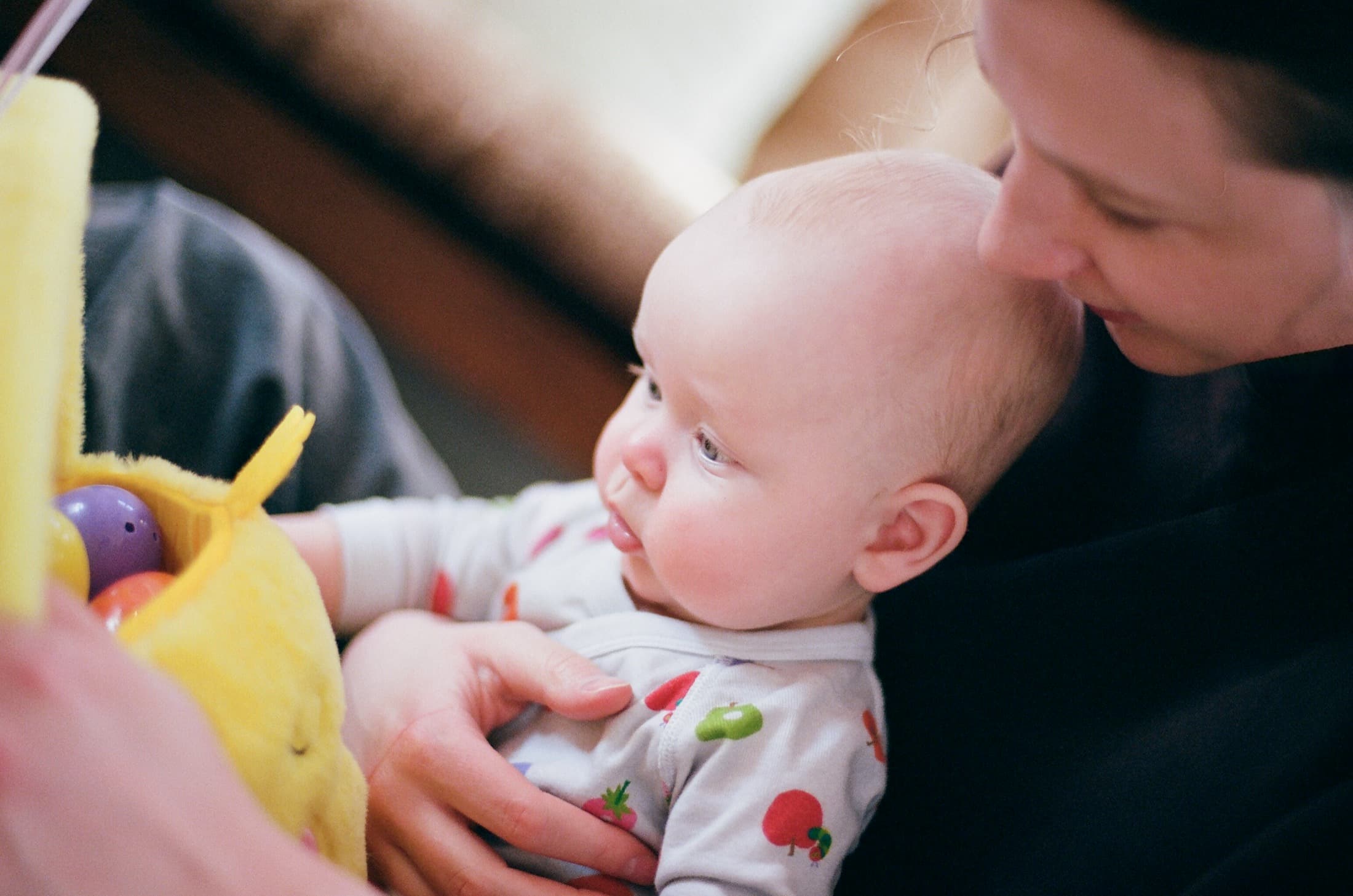 Lindsay holding Jude while he plays